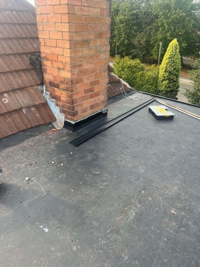 This is a photo of a flat roof which has just been repaired, there is also a chimney stack and some leadwork has also been dressed. Works carried out by Nettleham Roofing Repairs